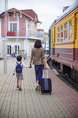 Image showing Mother and son goes on the landside platform