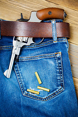 Image showing revolver under a leather belt