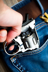 Image showing hand pulls out a revolver from the pocket