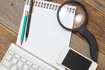 Image showing notebook, computer keyboard, pen, pencil and magnifying glass