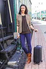 Image showing woman on the steps of an old passenger rail car