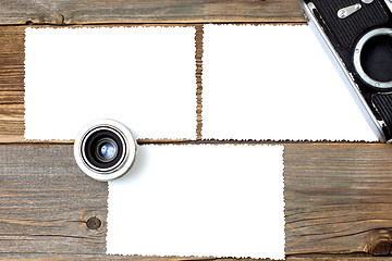 Image showing mock up photo, lens and vintage camera on wooden table