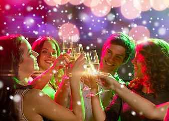 Image showing smiling friends with glasses of champagne in club