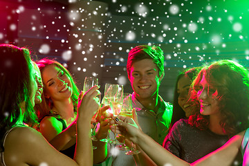 Image showing smiling friends with glasses of champagne in club