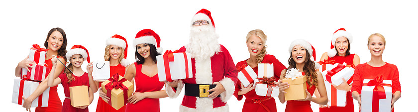 Image showing santa calaus and happy women with gift boxes