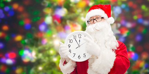 Image showing man in costume of santa claus with clock