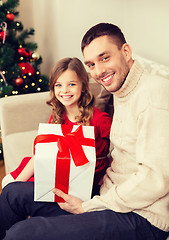 Image showing smiling father and daughter holding gift box