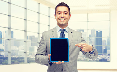 Image showing happy businessman in suit showing tablet pc screen