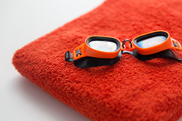 Image showing close up of swimming goggles and towel