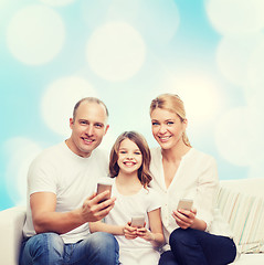 Image showing happy family with smartphones