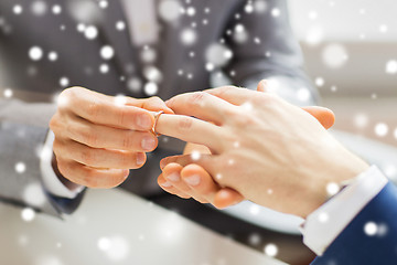 Image showing close up of male gay couple hands and wedding ring