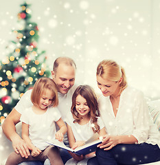 Image showing happy family with book at home