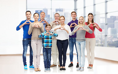 Image showing group of smiling people showing heart hand sign