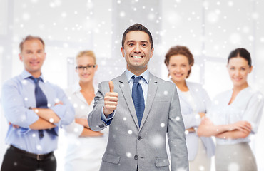 Image showing happy businessman in suit showing thumbs up