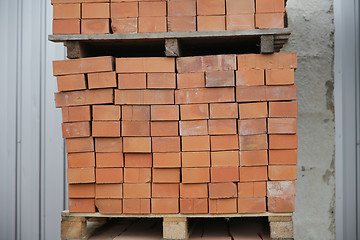 Image showing brown bricks batch on wooden storage tray