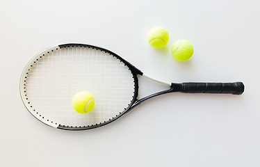 Image showing close up of tennis racket with balls