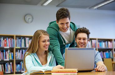 Image showing happy students with laptop in library