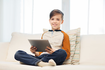 Image showing smiling boy with tablet computer at home