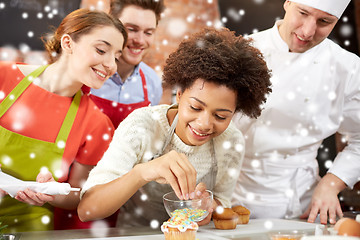 Image showing happy friends and chef cook baking in kitchen