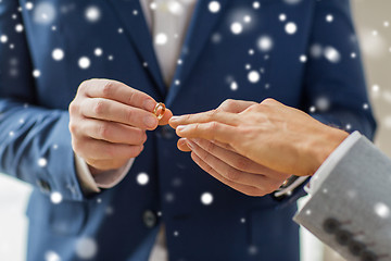 Image showing close up of male gay couple hands and wedding ring