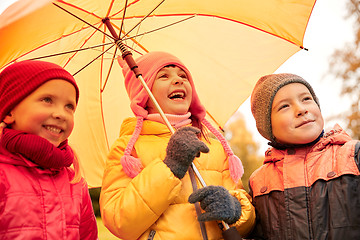 Image showing happy children with umbrella in autumn park