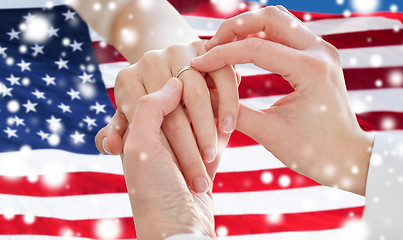 Image showing close up of lesbian couple hands with wedding ring