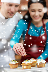 Image showing happy woman and chef cook baking in kitchen