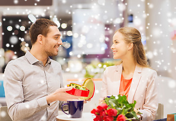 Image showing happy couple with chocolate box and roses in mall