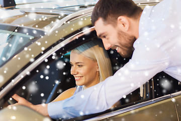 Image showing happy couple buying car in auto show or salon