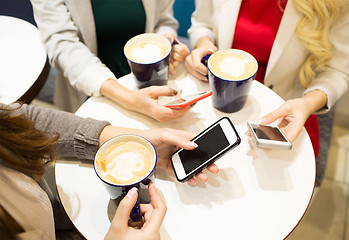 Image showing close up of hands with coffee cups and smartphones