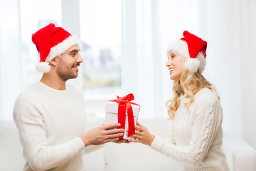 Image showing happy couple at home with christmas gift box