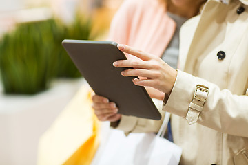 Image showing close up of women with tablet pc and shopping bags