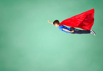 Image showing boy in red superhero cape and mask flying on air