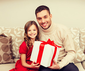 Image showing smiling father and daughter holding gift box