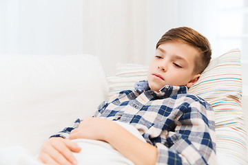 Image showing ill boy with flu lying in bed at home