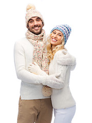 Image showing smiling couple in winter clothes hugging