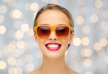 Image showing happy young woman in sunglasses with pink lipstick