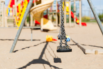 Image showing close up of swing on playground outdoors