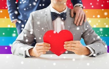 Image showing close up of male gay couple with red heart