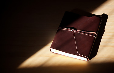 Image showing closed brown leather diary with flap and lacing