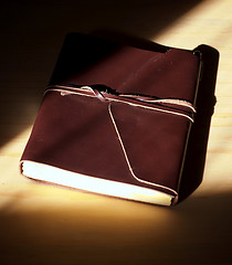 Image showing glowing leather bound book