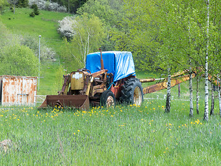 Image showing one yellow old and rusty tractor 