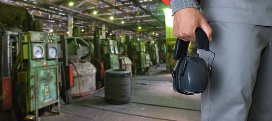 Image showing Worker with protective headphone
