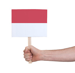 Image showing Hand holding small card - Flag of Monaco