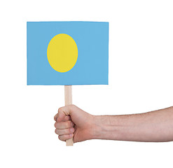 Image showing Hand holding small card - Flag of Palau