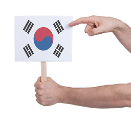 Image showing Hand holding small card - Flag of South Korea