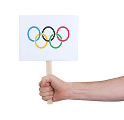 Image showing Hand holding small card - Flag of the Olympic games