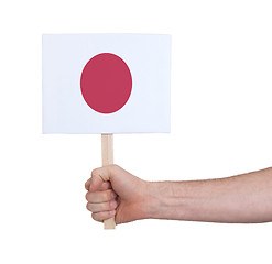 Image showing Hand holding small card - Flag of Japan