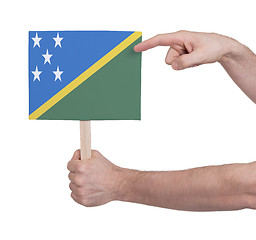 Image showing Hand holding small card - Flag of Solomon Islands