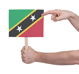 Image showing Hand holding small card - Flag of Saint Kitts and Nevis